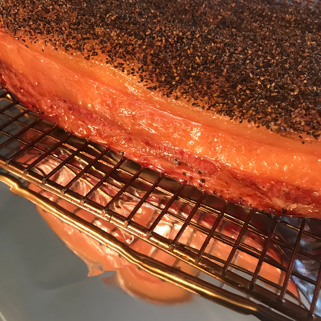 Freshly Smoked Bacon on wire rack on foil